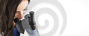 Female doctor looking through a microscope