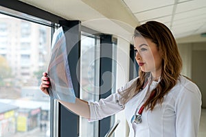 Female doctor looking at x-ray image of lungs radiography