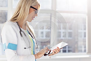 Female doctor looking on tablet computer