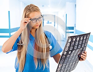 Female doctor looking at tomogram photo