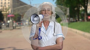 Female doctor making an announcement through megaphone.