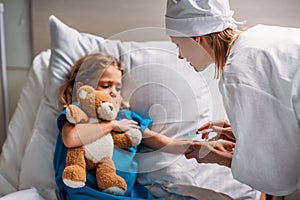 female doctor making vaccination to scared