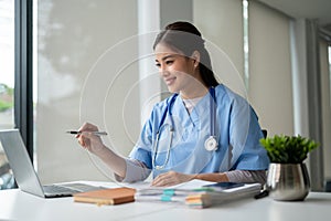 A female doctor is making a video call medical consultation with a patient