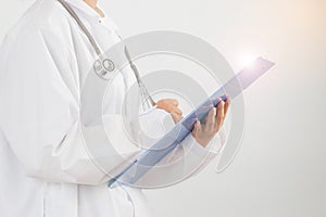 Female doctor medical physician writing prescription clipboard with record information paper over with gown suite wearing