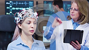 Female doctor in neuroscience using a futuristic device