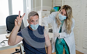 Female doctor or nurse giving shot or vaccine to a patient. Vaccination and prevention concept