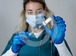 Female doctor or nurse holding COVID-19 Vaccine. Coronavirus medical treatment