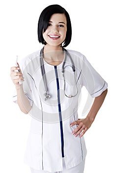 Female doctor or nurse holding digital thermometer