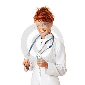 Female doctor or nurse holding syringe