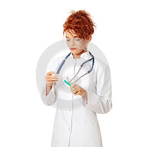 Female doctor or nurse holding syringe