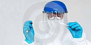 Female doctor or nurse in protective suit takes a specimen swab