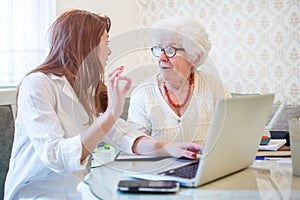 Female doctor or nurse showing ok sign to senior patient. Medicine, age, health care and home care concept
