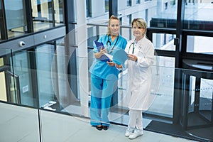 Female doctor and nurse standing in corridor