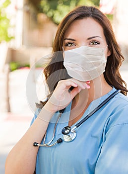 Female Doctor or Nurse Wearing Protective Face Mask