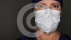 Female Doctor or Nurse Wearing Surgical Mask and Cap Slowly Moving From Side to Side