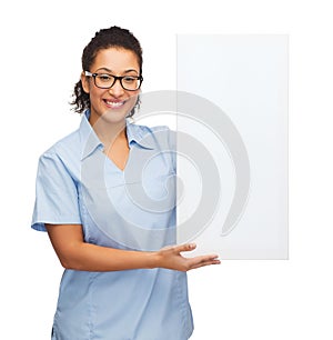 Female doctor or nurse with white blank board