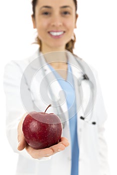 Female doctor offering an apple