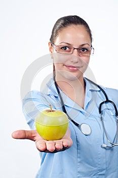 Female doctor offering green apple