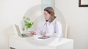 Female Doctor in office working on laptop