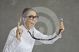 Female doctor with opened mouth widely wearing stethoscope understand something