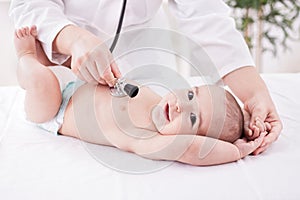 Female doctor pediatrician and patient happy smiling child baby