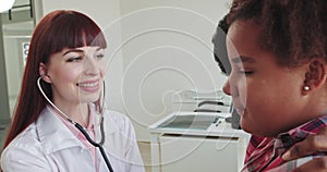 Female Doctor Pediatrician Using Stethoscope Listen to the Heart of Kid Girl at Medical Visit With Mother in the