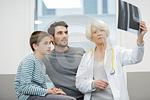 female doctor pediatrist and boy looking at xray photo