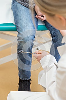 Female doctor with percussion hammer