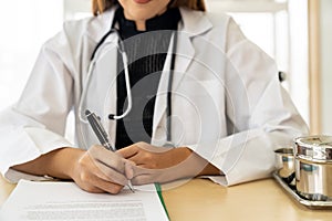 Female doctor portrait sign document