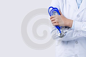 Female doctor portrait, young woman physican holding a stethoscope isolated on white background, close up, cropped view, copy
