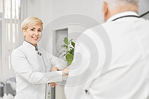 Female doctor posing near hospital reception.