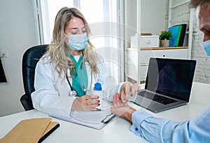 Female doctor prescribing medication to patient