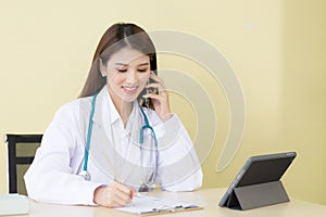 Female doctor provides telephone consultation.