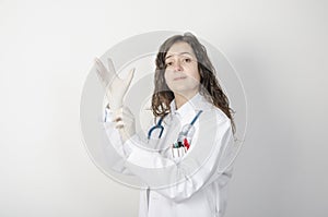 Female doctor putting latex gloves.