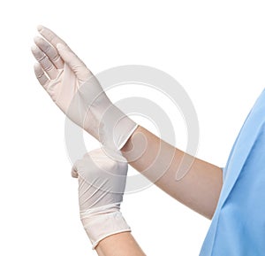 Female doctor putting on rubber gloves against white background, closeup.
