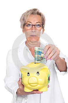 Female doctor with piggy bank