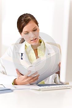 Female doctor read book in clinic