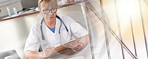 Female doctor reading a clinical record  multiple exposure