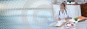 Female doctor reading a clinical record  panoramic banner