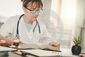 Female doctor reading a textbook