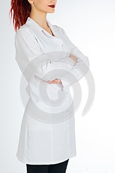 Female doctor with red hair. white background. stethoscope file and white uniform