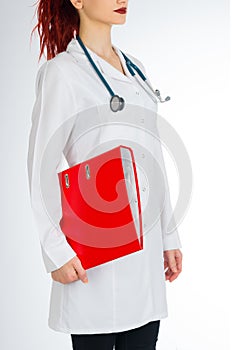 Female doctor with red hair. white background. stethoscope file and white uniform