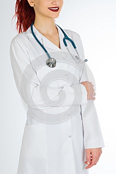 Female doctor with red hair. white background. stethoscope file and white uniform