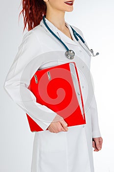 Female doctor with red hair. white background. stethoscope file and white uniform