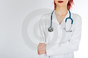 Female doctor with red hair. white background. stethoscope file and white uniform