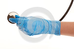 Female doctor's hand in blue sterilized surgical glove with stethoscope