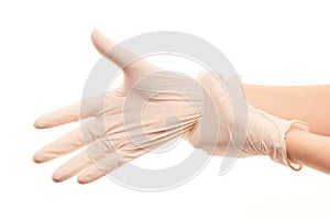 Female doctor's hands putting on white sterilized surgical gloves