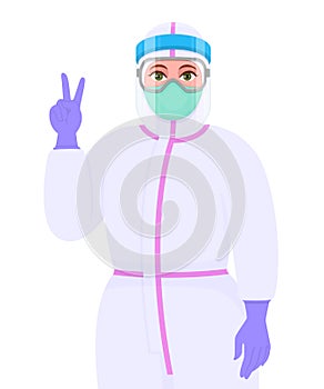 Female doctor in safety protective suit, mask and face shield showing victory or peace gesture sign. Physician gesturing success
