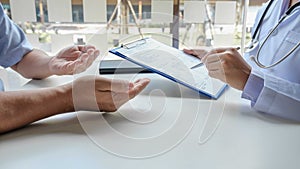 The female doctor sat on the examination of the patient`s history and was ready to listen to the patient to clarify the symptoms.