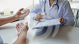 The female doctor sat on the examination of the patient`s history and was ready to listen to the patient to clarify the symptoms.